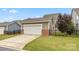 Two car detached garage with a wide driveway and well-maintained landscaping at 1020 Bannister Rd, Waxhaw, NC 28173
