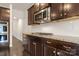 Modern kitchen with stainless steel appliances, granite counters, and dark wood cabinetry at 1020 Bannister Rd, Waxhaw, NC 28173