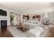Spacious open-concept living area with modern furniture, fireplace, and kitchen view at 1020 Bannister Rd, Waxhaw, NC 28173