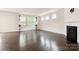 Bright living room featuring dark wood floors, a fireplace, and large windows at 1020 Bannister Rd, Waxhaw, NC 28173