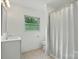 Bathroom with white vanity, toilet, and shower-tub combination at 1038 Blake Rd, Albemarle, NC 28001