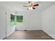 Well-lit bedroom with wood-look flooring, fresh paint, ceiling fan, and a large window at 1038 Blake Rd, Albemarle, NC 28001