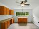 Bright bonus room with ceiling fan, hardwood style flooring, and built in cabinets at 1038 Blake Rd, Albemarle, NC 28001
