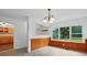 The dining room features wood paneling and large windows offering natural light at 1038 Blake Rd, Albemarle, NC 28001