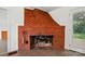 Living room showcasing a brick fireplace and tile flooring at 1038 Blake Rd, Albemarle, NC 28001
