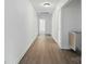 Long hallway with wood-look flooring and white walls, showcasing the home's layout at 1038 Blake Rd, Albemarle, NC 28001