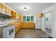 Well-lit kitchen featuring wood cabinets, tile floors, and modern appliances at 1038 Blake Rd, Albemarle, NC 28001