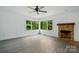 Bright living room with new flooring, a fireplace, and a large window with a view of the yard at 1038 Blake Rd, Albemarle, NC 28001