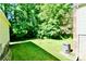 Well-maintained backyard featuring green grass and privacy offered by mature trees at 105 Venus Ave, Gastonia, NC 28052
