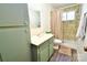 Full bathroom featuring a shower, vanity and updated flooring for a functional space at 105 Venus Ave, Gastonia, NC 28052