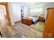 Bedroom featuring a wooden chest, closets and updated flooring for a cozy and organized space at 105 Venus Ave, Gastonia, NC 28052