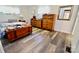 Bedroom featuring a wooden chest, dresser, and updated flooring for a cozy and organized space at 105 Venus Ave, Gastonia, NC 28052