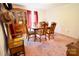 Traditional dining room with a wooden table set, a vintage china cabinet, and warm pink carpet at 105 Venus Ave, Gastonia, NC 28052