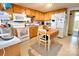 Inviting eat-in kitchen featuring wood cabinetry, updated appliances, and cozy dining space at 105 Venus Ave, Gastonia, NC 28052