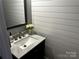 Stylish powder room featuring shiplap walls, a modern vanity, and elegant fixtures at 110 W Pine St, Lincolnton, NC 28092