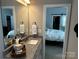 Neutral bathroom featuring granite countertop with a framed mirror and doorway to the bedroom at 110 W Pine St, Lincolnton, NC 28092