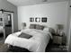 Comfortable bedroom with shiplap accent wall, lamps, and sliding closet doors at 110 W Pine St, Lincolnton, NC 28092