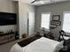 Bright bedroom with exercise bike, ceiling fan, and dark wood dresser at 110 W Pine St, Lincolnton, NC 28092