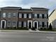 Charming townhomes featuring brick exteriors, black shutters, and well-maintained landscaping at 110 W Pine St, Lincolnton, NC 28092