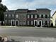 Charming townhomes featuring brick exteriors, black shutters, and well-maintained landscaping at 110 W Pine St, Lincolnton, NC 28092