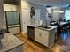 Open-concept kitchen featuring a center island, stainless steel appliances, and hardwood floors at 110 W Pine St, Lincolnton, NC 28092