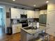 Bright kitchen featuring white cabinets, granite countertops, and stainless steel appliances at 110 W Pine St, Lincolnton, NC 28092