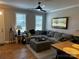 Inviting living room featuring a cozy couch, windows, and natural light at 110 W Pine St, Lincolnton, NC 28092