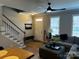 Spacious living room featuring stairs, couch, and front door at 110 W Pine St, Lincolnton, NC 28092