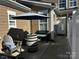 Cozy outdoor patio with comfortable seating, umbrella, and stylish barrel table at 110 W Pine St, Lincolnton, NC 28092