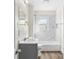 Beautiful bathroom featuring a shower over the tub, marble tiling, and modern fixtures at 1102 Venus St, Kannapolis, NC 28083