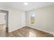 Inviting bedroom with wood floors, soft paint, a closet, and a window with outside view at 1102 Venus St, Kannapolis, NC 28083