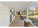 Spacious front porch featuring wood flooring, white pillars, and brick accents that provide a relaxing outdoor space at 1102 Venus St, Kannapolis, NC 28083