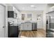Modern kitchen with white cabinets, stainless steel appliances, and updated flooring at 1102 Venus St, Kannapolis, NC 28083
