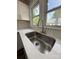 Modern kitchen sink with stainless steel faucet, quartz countertops, and subway tile backsplash at 1102 Venus St, Kannapolis, NC 28083