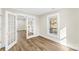 Sunlit living room showcases wood floors, white trim, and french doors leading to another room at 1102 Venus St, Kannapolis, NC 28083
