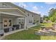 Well-maintained backyard with a covered patio, built-in grill, seating, fire pit and lush landscaping, perfect for relaxing outdoors at 11209 Flenniken Ct, Charlotte, NC 28277