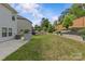 Landscaped backyard with terraced retaining wall and tall brown privacy fence at 11209 Flenniken Ct, Charlotte, NC 28277
