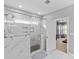 Bathroom features a marble walk-in shower, tile flooring and a window at 11209 Flenniken Ct, Charlotte, NC 28277
