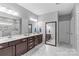 Bathroom features a double vanity, marble floors, and large framed mirror at 11209 Flenniken Ct, Charlotte, NC 28277