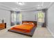 Spacious bedroom featuring a large bed with unique headboard and tray ceiling at 11209 Flenniken Ct, Charlotte, NC 28277