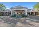 Elegant clubhouse entrance with a manicured circular driveway, featuring stone accents and beautiful landscaping at 11209 Flenniken Ct, Charlotte, NC 28277