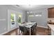 Bright dining room features a modern chandelier, with easy access to the outdoor patio at 11209 Flenniken Ct, Charlotte, NC 28277