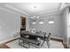 Bright dining room with a modern chandelier, tray ceiling, and stylish seating for sophisticated gatherings at 11209 Flenniken Ct, Charlotte, NC 28277