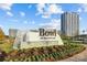 View of The Bowl entrance sign with greenery in Ballantyne, surrounded by modern buildings at 11209 Flenniken Ct, Charlotte, NC 28277
