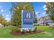 View of Ballantyne Village signage surrounded by beautiful landscaping and a clear blue sky at 11209 Flenniken Ct, Charlotte, NC 28277