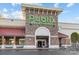 The exterior of a Publix supermarket, featuring its iconic green sign and stone facade at 11209 Flenniken Ct, Charlotte, NC 28277