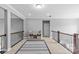 Upstairs hallway with decorative shelving and a black and white rug runner at 11209 Flenniken Ct, Charlotte, NC 28277