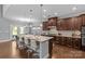 Open-concept kitchen with a large island, stainless steel appliances, and hardwood floors, ideal for cooking and socializing at 11209 Flenniken Ct, Charlotte, NC 28277