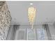 Living room featuring a stone fireplace and a decorative, modern chandelier at 11209 Flenniken Ct, Charlotte, NC 28277