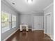 Bright office space with large windows and wood floors, featuring a writing desk at 11209 Flenniken Ct, Charlotte, NC 28277